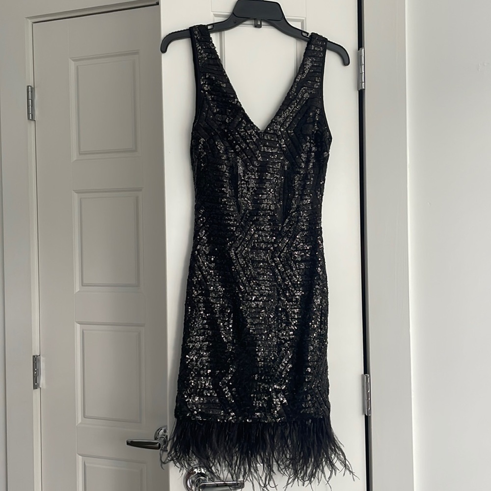 Almost new Black Sequined with Feathers on bottom Dress by B Darlin.